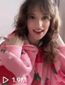 Case study results for Bloozie brand campaign, featuring a smiling UGC creator in a pink hoodie with strawberry graphics, showcasing high performance metrics.